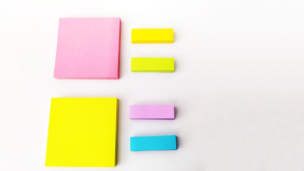 Hands sorting colorful document folders on desk